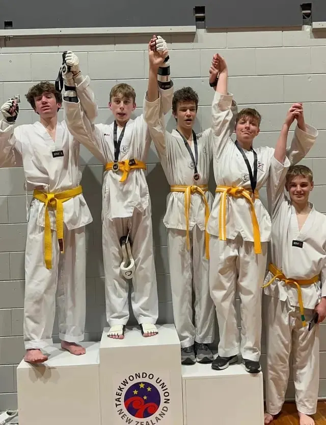 Students celebrating with their gradings and medals
