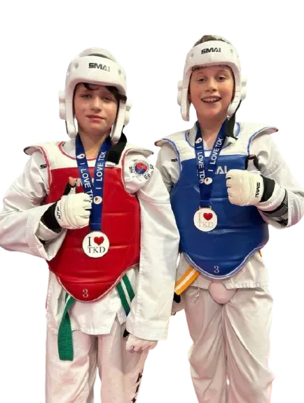 Two young students holding their belts